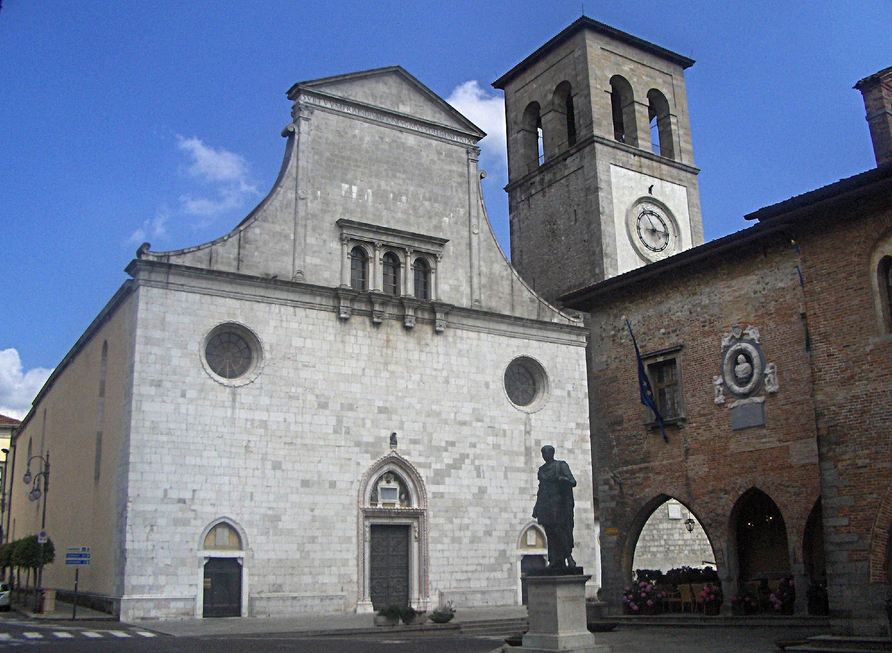 White stone facade of Cividale cathedral beside the Palazzo Comunale