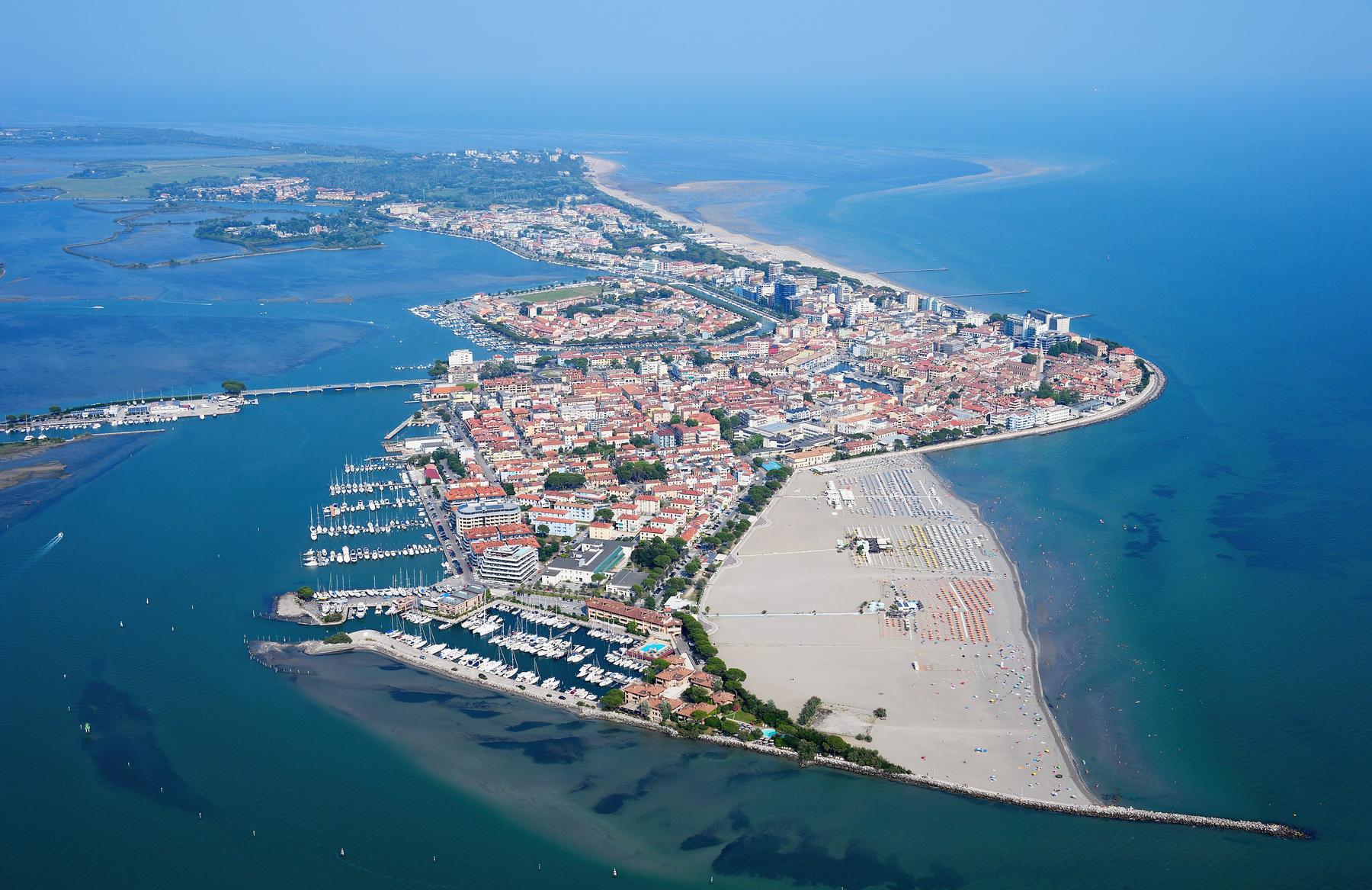 Aerial view of Grado's old town, marinas, beach and lagoon