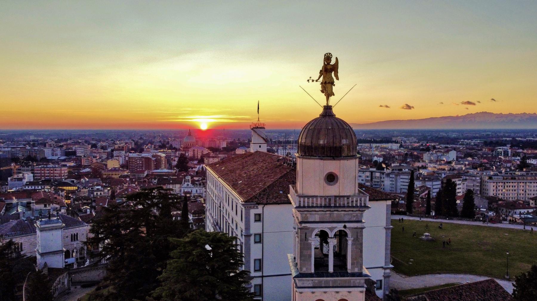 Sunset over Udine from the castle hill with Santa Maria di Castello's golden angel