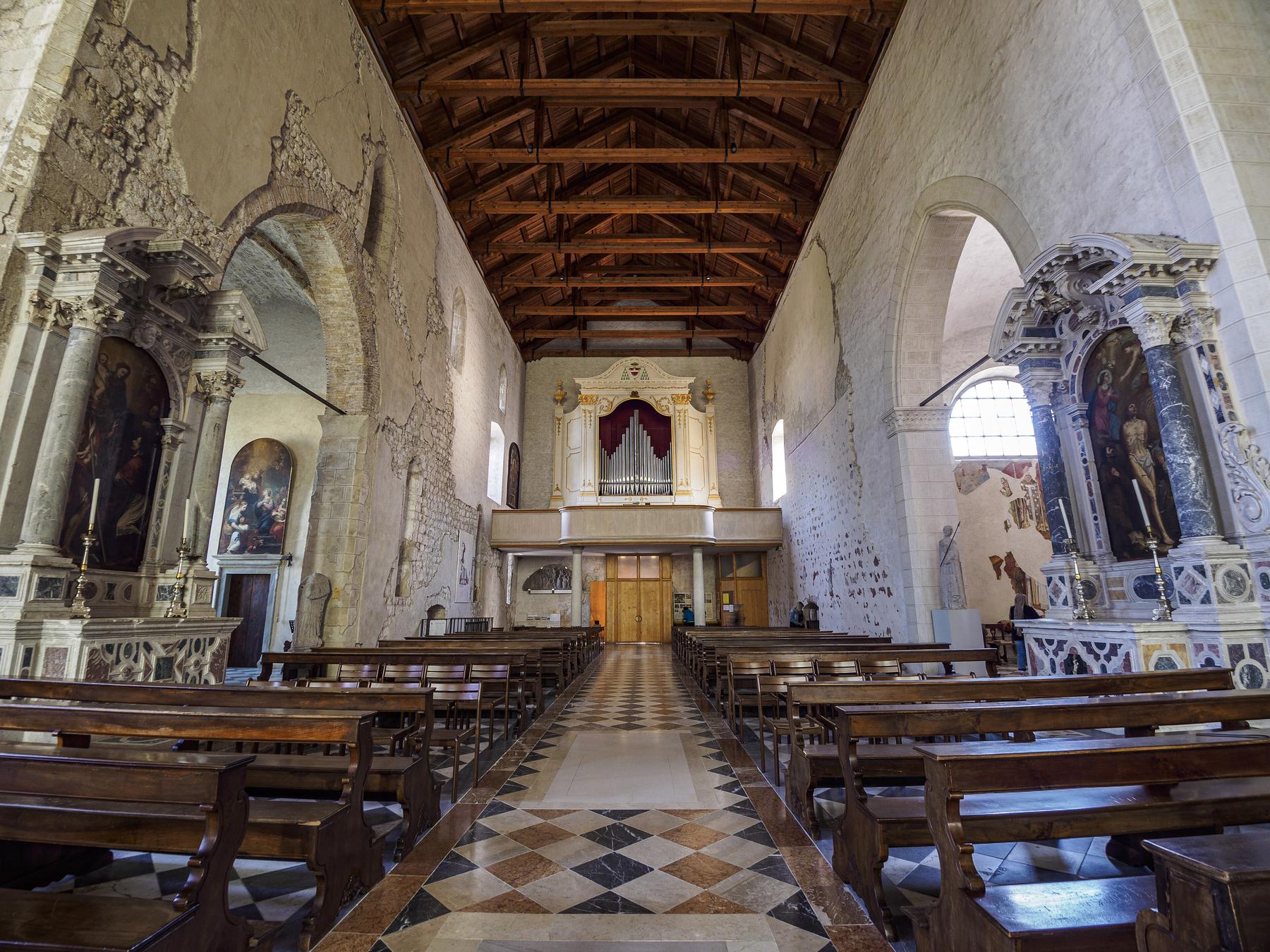 Nave of Venzone cathedral with timber roof, Baroque altars and organ